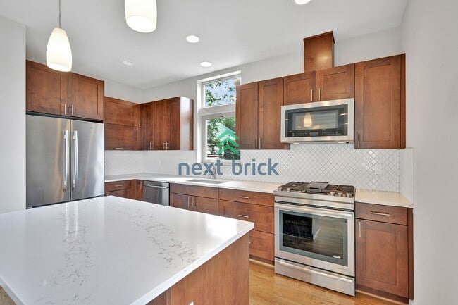 Building Photo - Sleek and Spacious Townhome with Gourmet K...