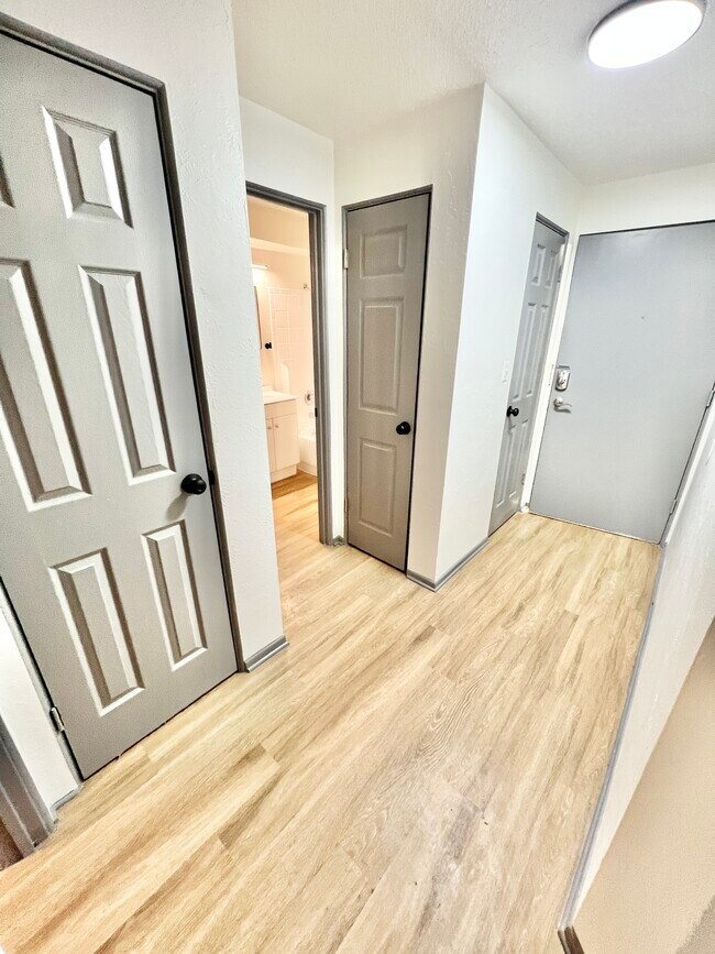 Step into a contemporary space featuring sleek design and functionality. - Melody Apartments
