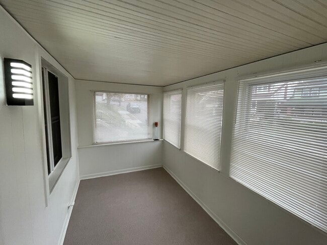 Pleasant sunroom with fresh nature stone flooring. - 212 Lorenz Ave