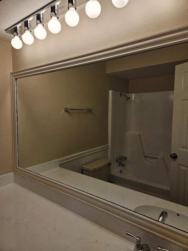 Building Photo - Three bedroom and two bathroom nicely remodeled with new flooring. Large wood fenced backyard