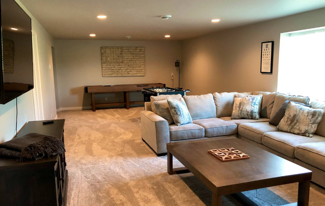 Basement Living room with foosball and shuffleboard - 345 Victory Ln