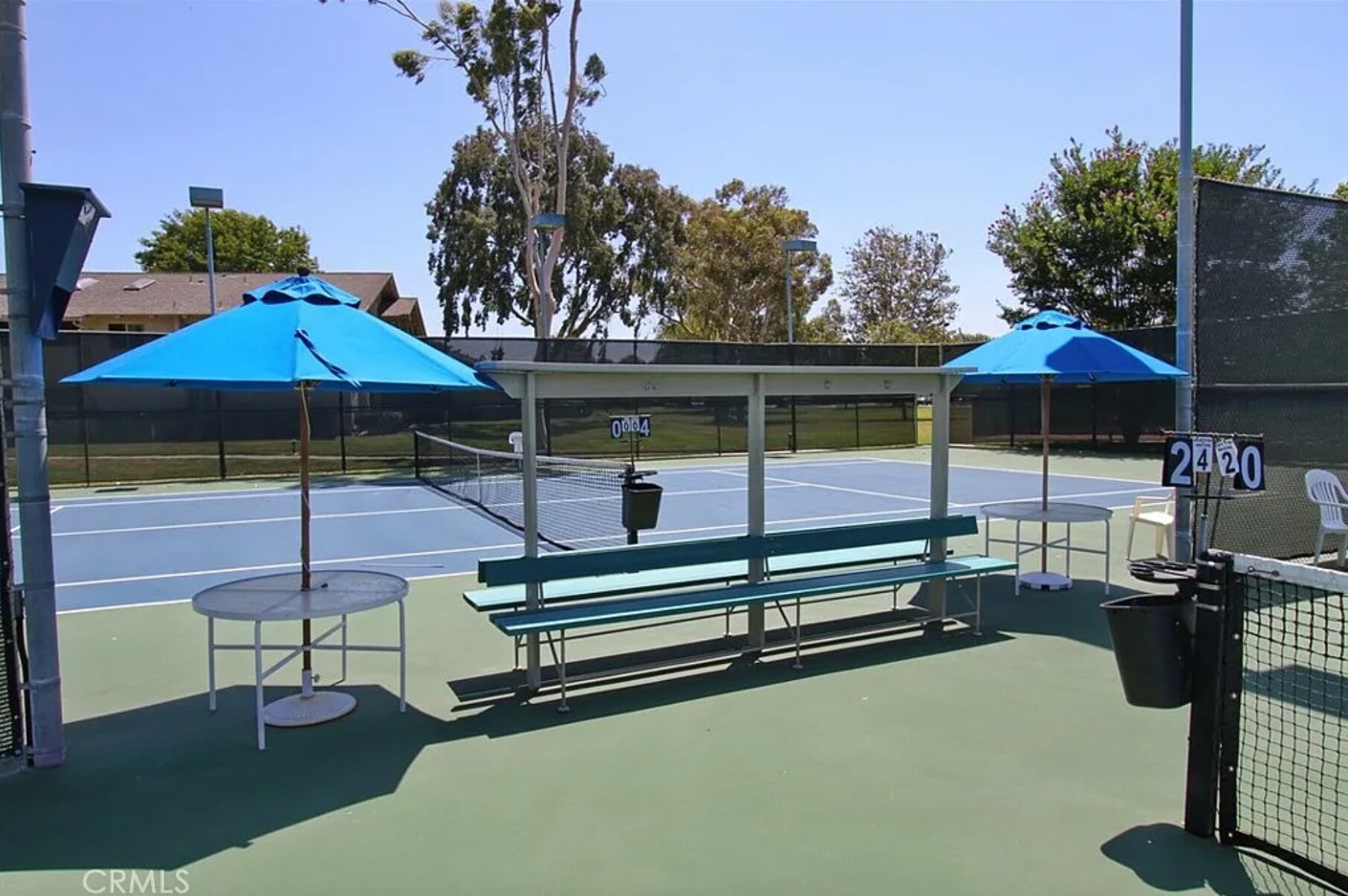Tennis court with shaded seating. - 8566 Larkhall Cir