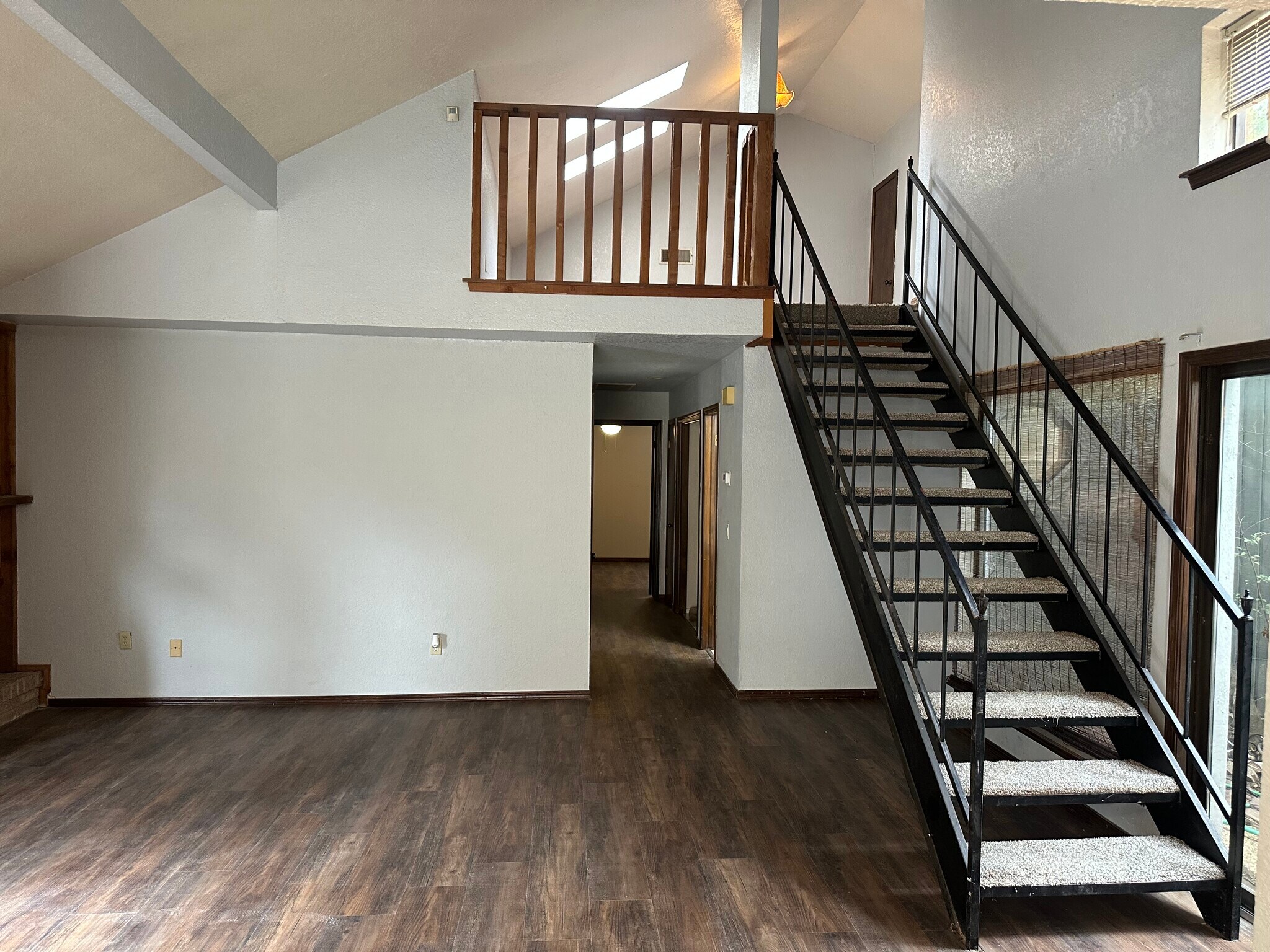 Living area with stairs to lo - 6107 Gaelic Glen Dr