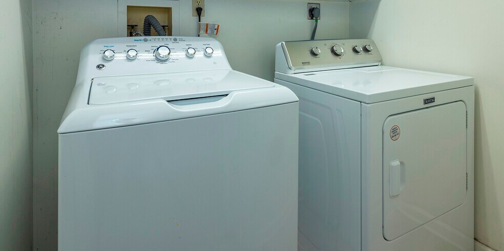 Dedicated utility room equipped with premium, high-efficiency washer and dryer units. - 405 Windswept Dr