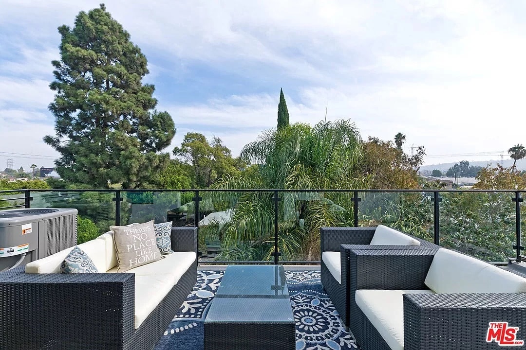 Top floor balcony looks over the tree tops - 6077 Hargis St