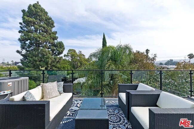 Top floor balcony looks over the tree tops - 6077 Hargis St