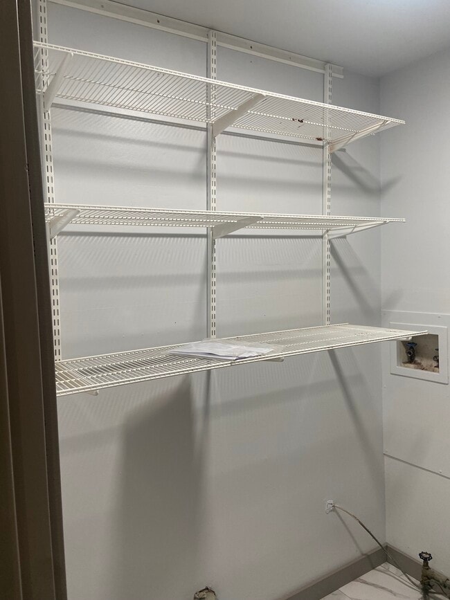 Laundry room with storage shelving - 174 Brisbane Ave
