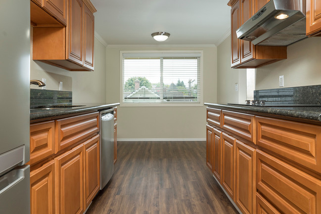 Gorgeous renovated kitchens with granite counters and stainless steel appliances - Vista Terrace Apartments