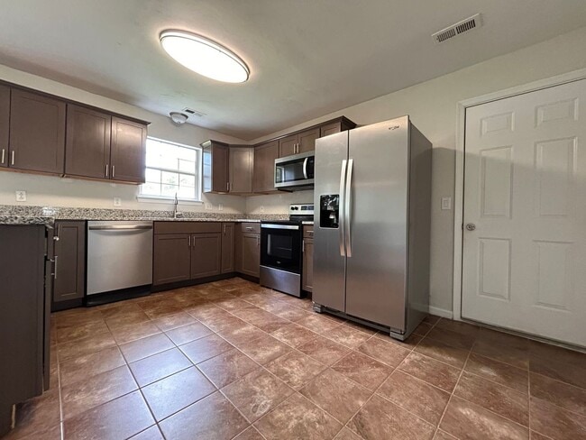 Building Photo - Spacious & Updated 4-Bedroom Gem in the He...