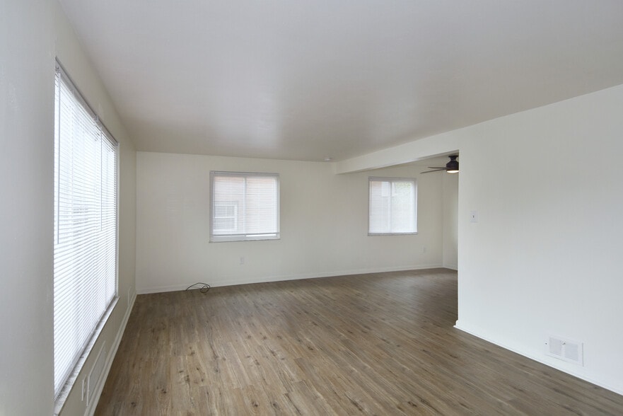 Freshly painted spacious living room with all-new luxury vinyl plank flooring and mini-blinds throug - 3156 Glendale Ave