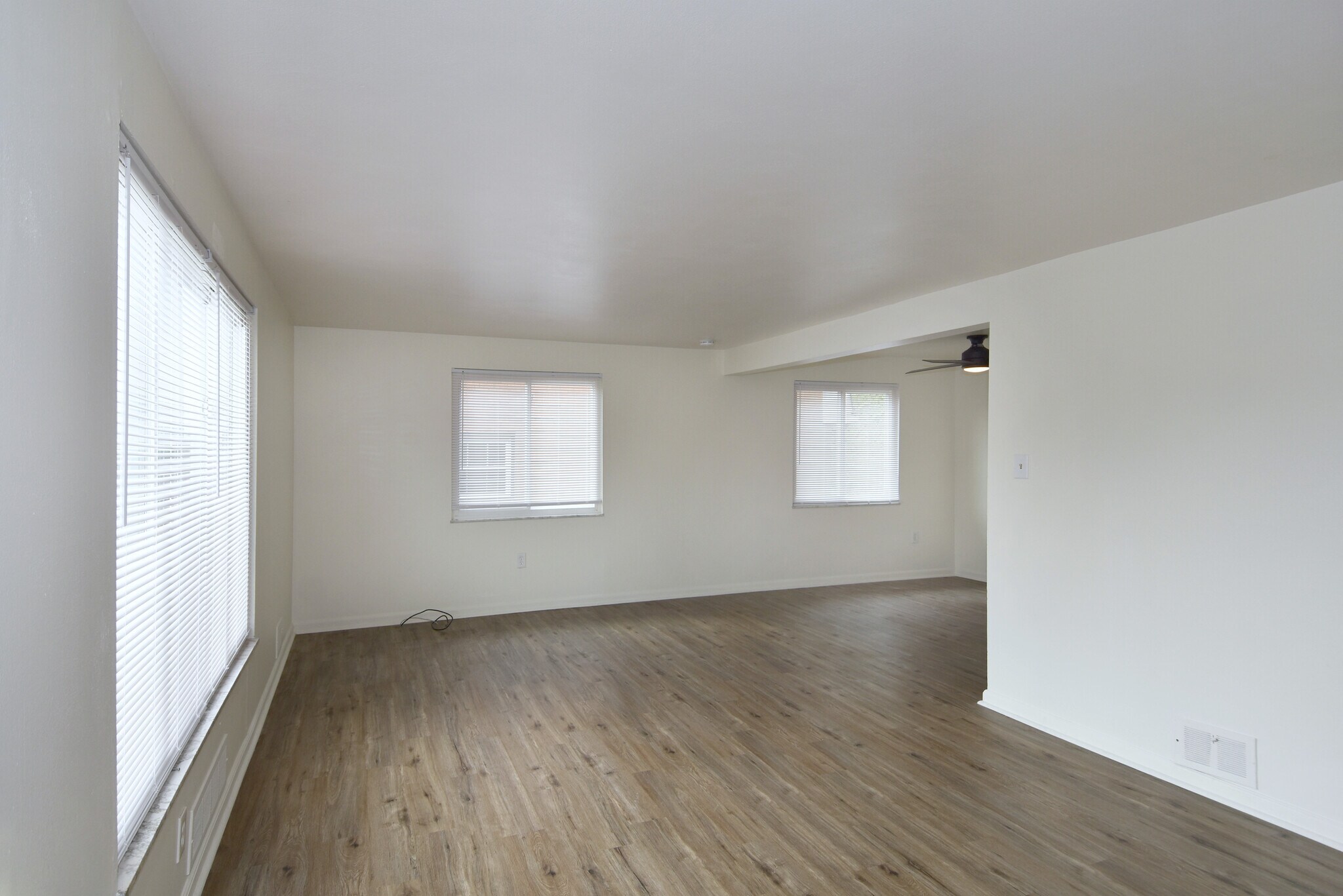 Freshly painted spacious living room with all-new luxury vinyl plank flooring and mini-blinds throug - 3156 Glendale Ave