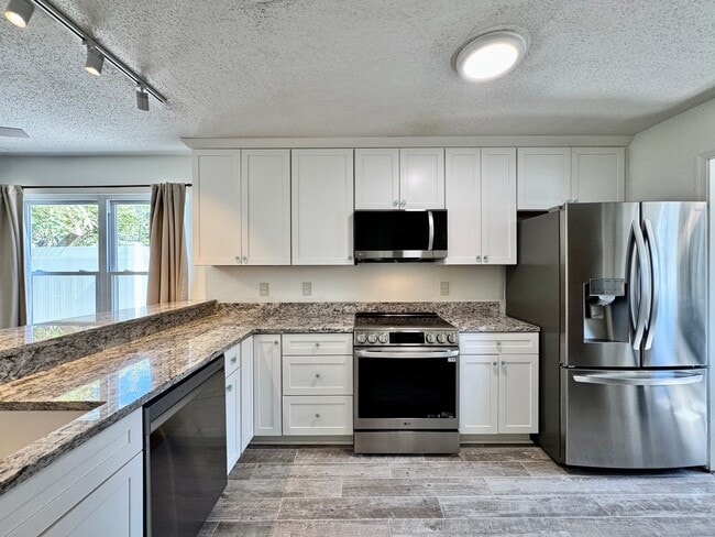 Building Photo - Ready NOW! A Custom Townhouse-Style Duplex Blocks to the Beaches! Fenced Yard - Hot Tub - Pet Fri...