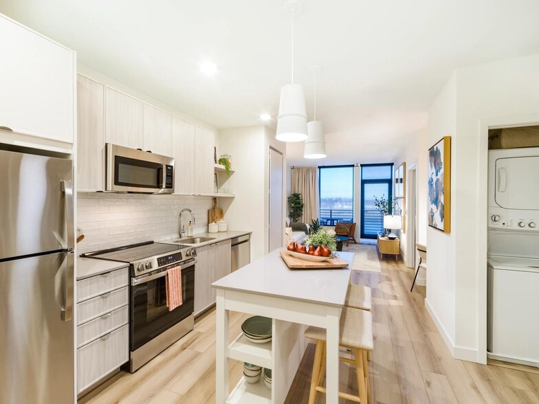An open kitchen with refined finishes, in-home laundry, and a seamless flow into your living space. - Modera Revere Beach
