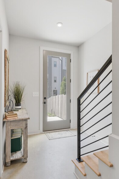 Bright and welcoming entryway with sleek finishes and modern rail detail. - 358 E Village Ln