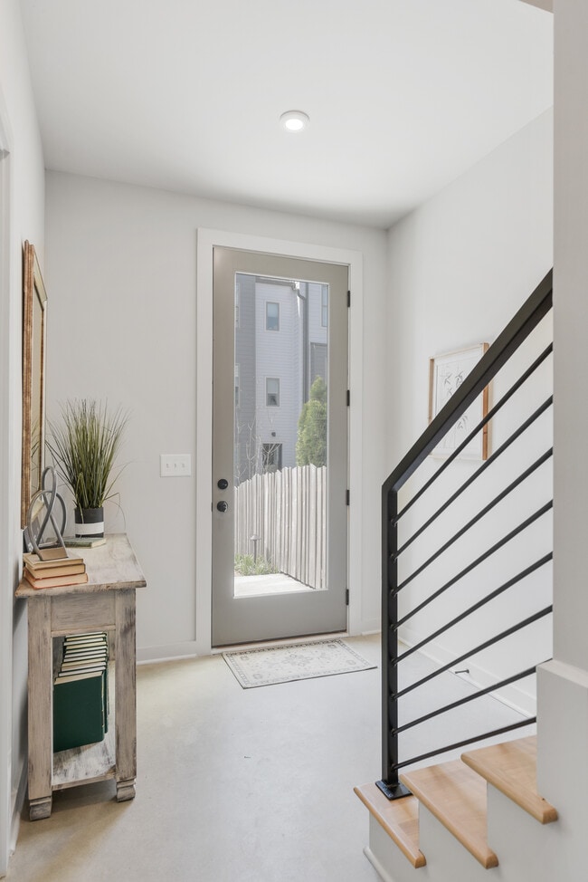 Bright and welcoming entryway with sleek finishes and modern rail detail. - 358 E Village Ln