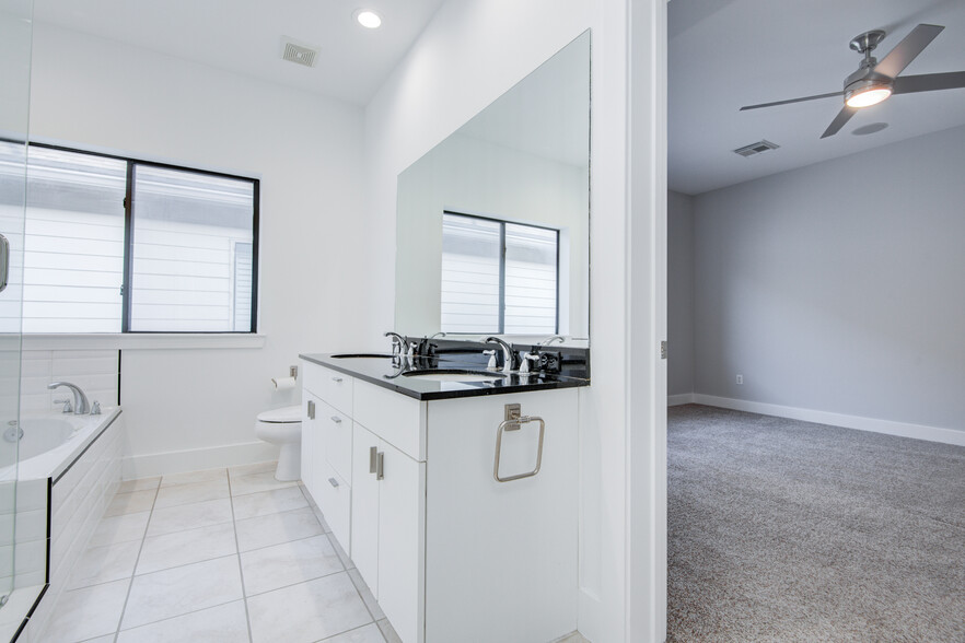 Master bathroom with double vanity sinks, walk-in shower and jacuzzi tub. - 4202 Spencer St