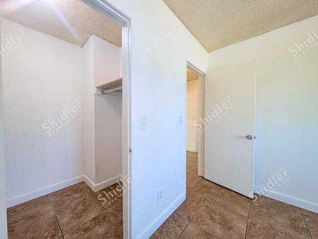 Building Photo - Upstairs 2 Bedroom 1 Bath with Massive Walk In Closet, Covered Gated Parking