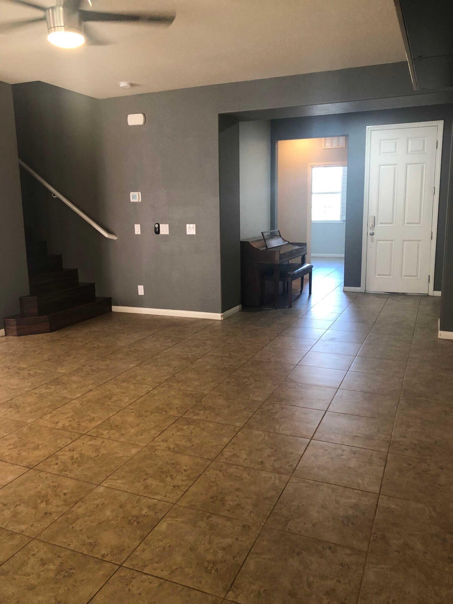 Entry doorway going to living room, a piano can be left as furnitures but we can remove it, beside the entry way is a bedroom or you can use as office with a full toilet and bath, we can label it a guestroom - 263 Garden Trellis Ct
