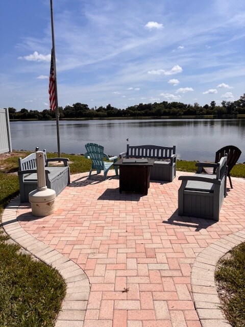 Relax after your scenic walk on the patio by the pond, just steps from the soothing water fountain - 9570 Green Cypress Ln