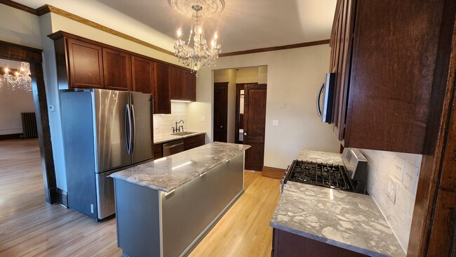 Full kitchen with marble counters and island - 1402 N Girard Ave N