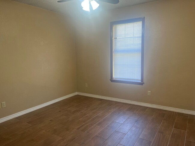 Building Photo - This cozy house features a fenced backyard...