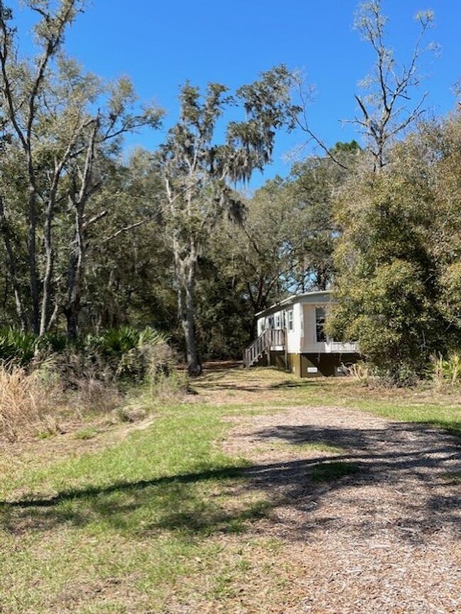 Building Photo - Charming 2-Bedroom Home on Spacious Wooded...