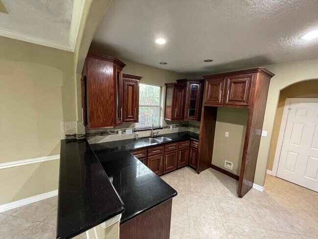 Kitchen, Custom built wood cabinets, black granite with gold flakes counter tops. - 600 River Bend Dr