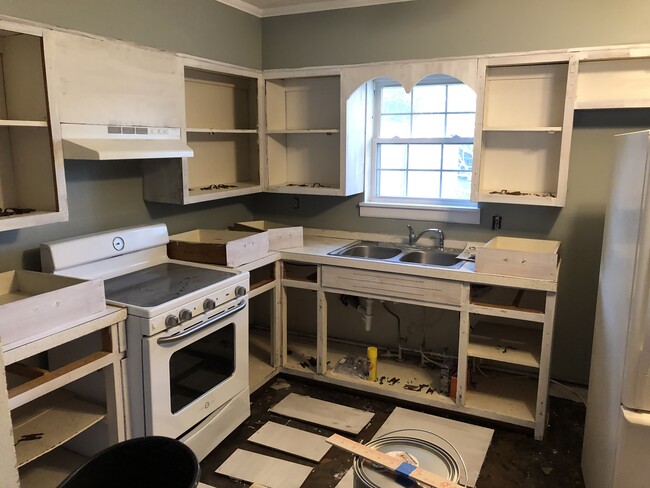 Kitchen all primed and ready for the new paint, counter top, hardware, and flooring. - 208 W Easy St