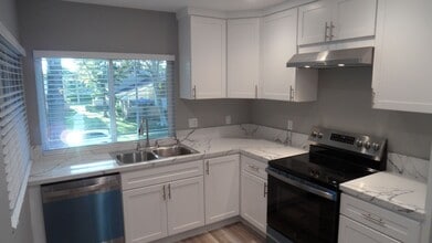 Building Photo - REMODELED 2BR; 1BA end unit condo w/ 1 car garage & 1 parking space