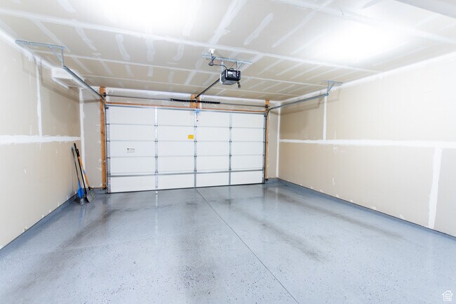 This is not the exact garage. Ours has some shelving built in and does not have epoxy - 413 S 1540 E