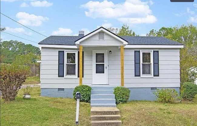 Charming single-family home with updated exterior, covered entry, and carport - 520 Commonwealth St