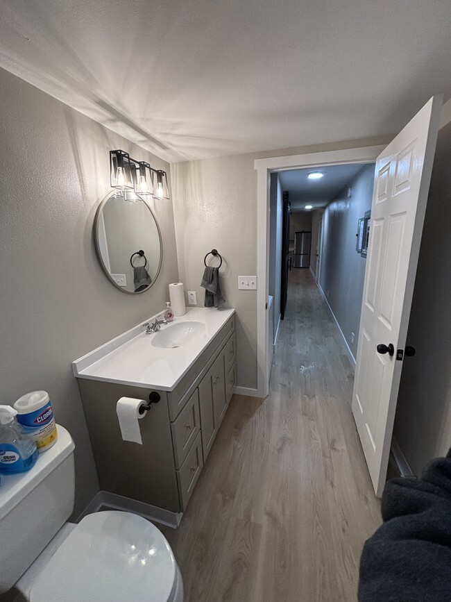 Bathroom with large vanity and a deep set bathtub - 1504 W 7th Pl