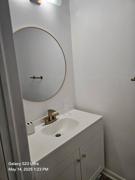 Newly installed vanity, fixtures, lighting, & mirror. - 2109 Point Hollow Ct