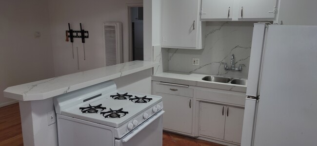 Quartz countertops, backsplash , stainless steel sink & tall neck faucet - 5042 Sawtelle Blvd