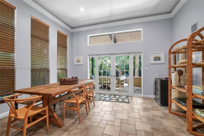 Dining room with French doors that lead to elevated outside terrace with retractable louvered roof - 1109 NE 3rd St