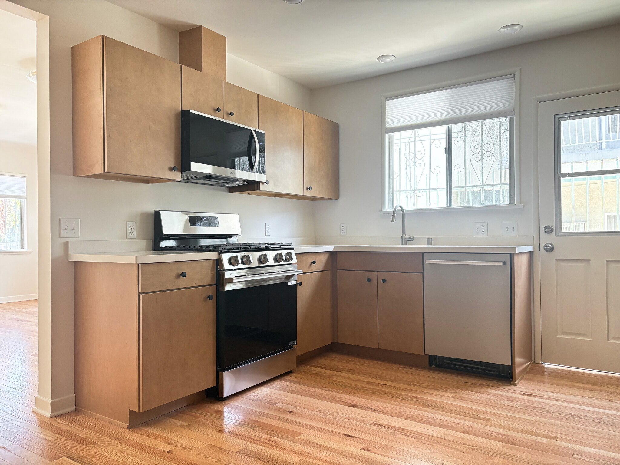 Kitchen with brand new stainless steel appliances, quartz countertops, and maple cabinets - 1041 Wilcox Ave