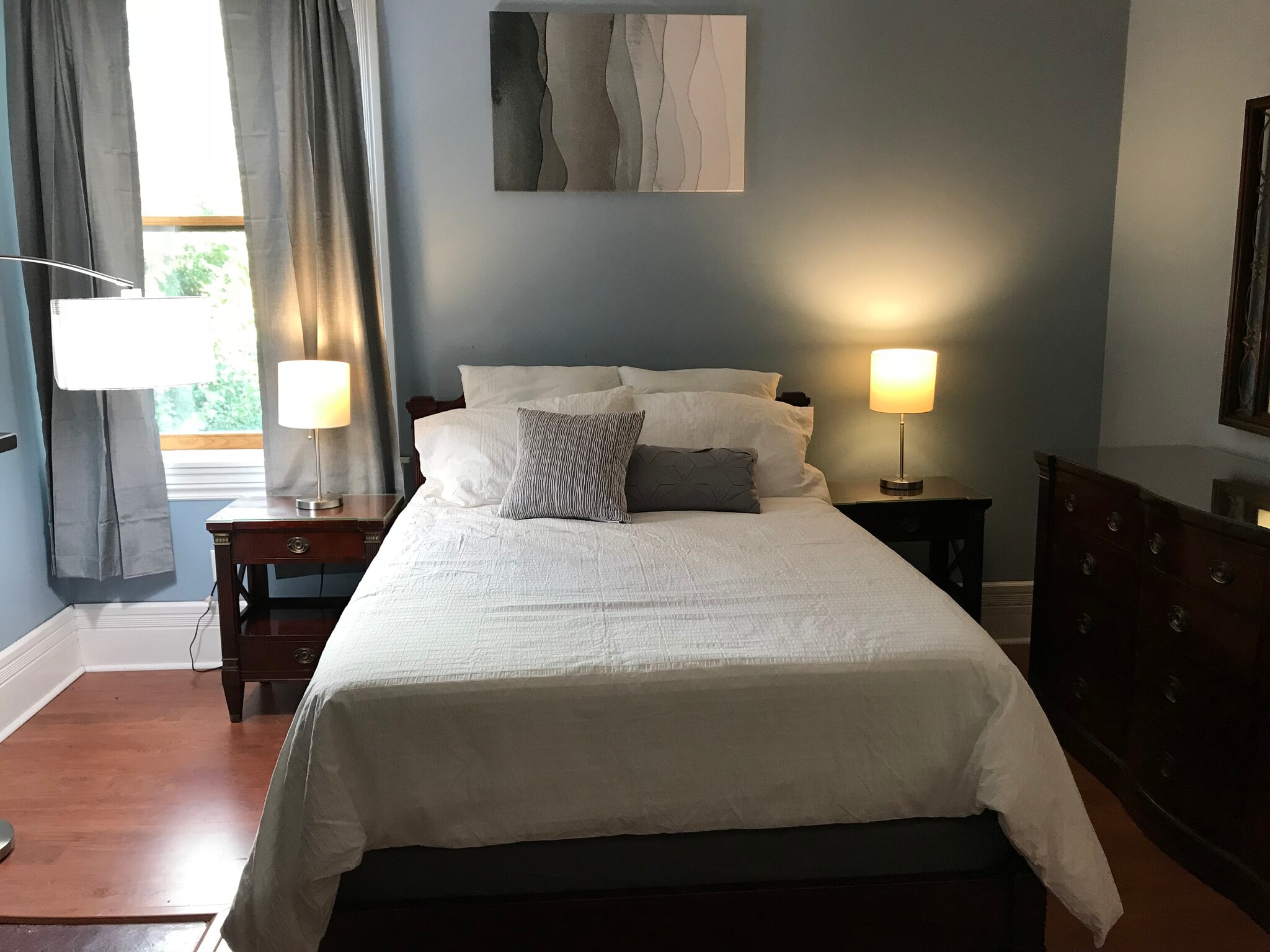 2nd floor: biggest bedroom. Furnished with a bed, 2 nightstands, a dresser with mirror, a chest of drawers, a desk and chair. This bedroom has a closet and 2 large windows. - 3284 Dawson Street