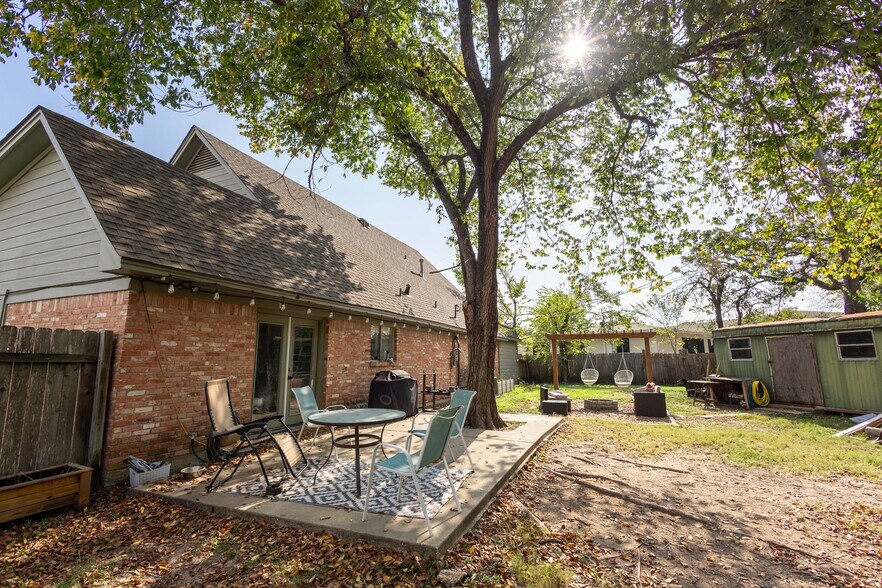 Backyard, showing pergola swingset, back porch, and enclosed shed. - 604 Avondale Ave