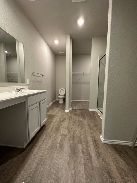 Master bathroom with wood finish floors - 2130 Dry Moss Pass