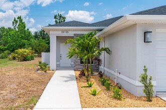 Building Photo - NEW Villa-duplex home with quartz counters, 2-car garage, and a rear patio