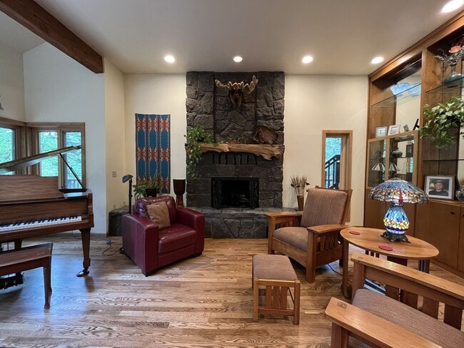 Building Photo - One-of-a-Kind Custom Home with Wall of Windows, Stone Fireplaces, Expansive Entertainment Space &...