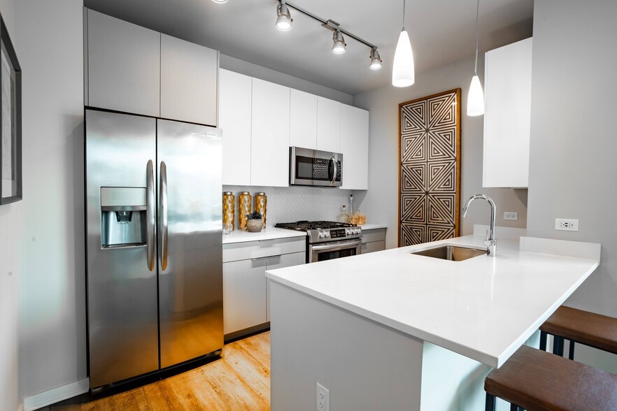 Unit Kitchen with Stainless Steel Appliances and Quartz Countertops at The Grand Central Apartments in Chicago, IL 60607 - The Grand Central