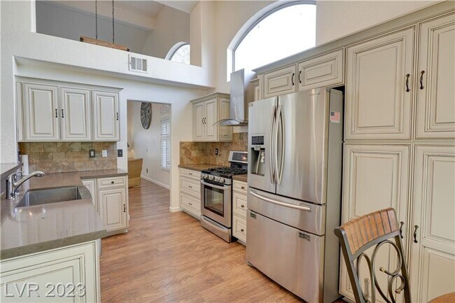 Building Photo - 4 BEDROOM HOME WITH PRIMARY BEDROOM DOWNST...