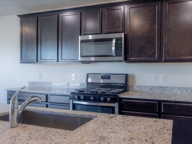 Building Photo - Spacious 4-Bedroom Home with Open Layout & Turf Backyard