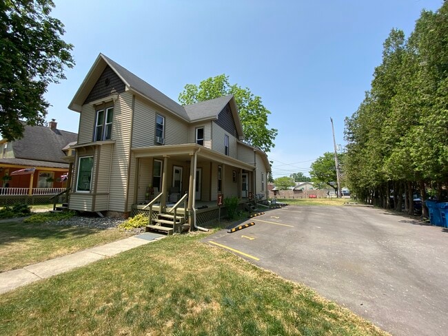 Front and side of house with large porch and parking area - 309 N Davison St