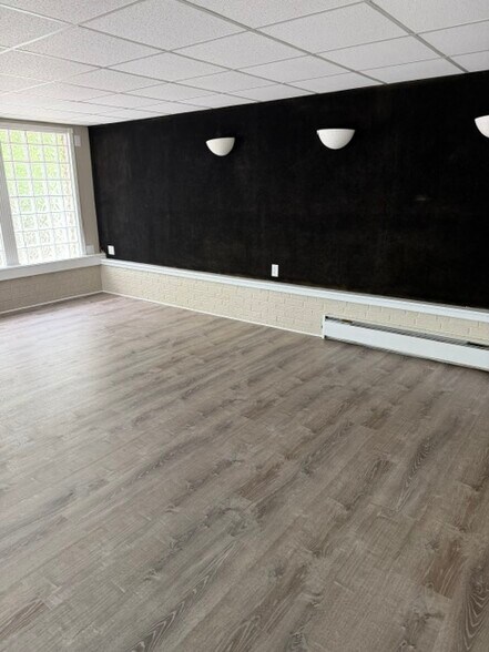 Large family room on lower level with door to garage and open living to kitchen and dining area - 4238 State Park Dr
