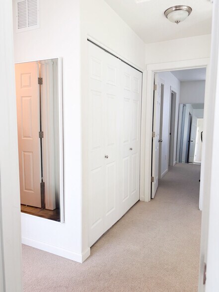 Upstairs hallway with easy access laundry closet - 15458 SW Mallard Dr