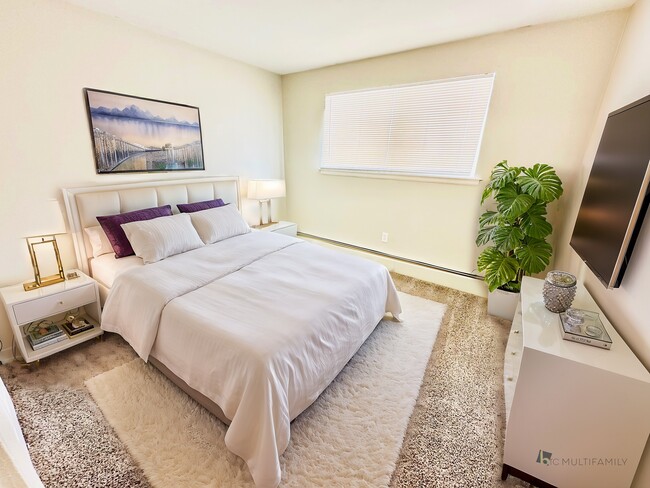 Experience comfort in this elegantly decorated bedroom, perfect for relaxation. - Hawk Point Apartments