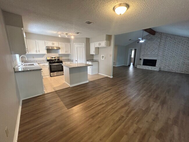 Renovated kitchen, new gas oven/range & new dishwasher Living room w/fireplace - 22011 Grand Forks Dr