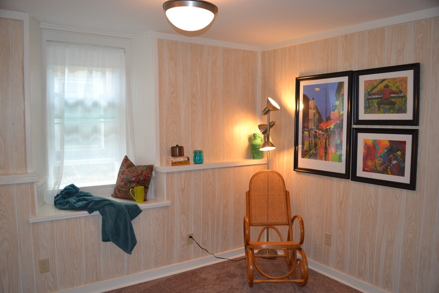 west wall of living room has another deep window well - 222 W Case St